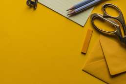 Office supplies against yellow background