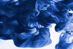 Blue ink swirling in water