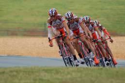 Group of orange-outfitted bicyclists