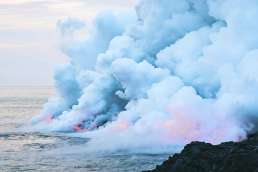 Lava entering ocean and steam rising