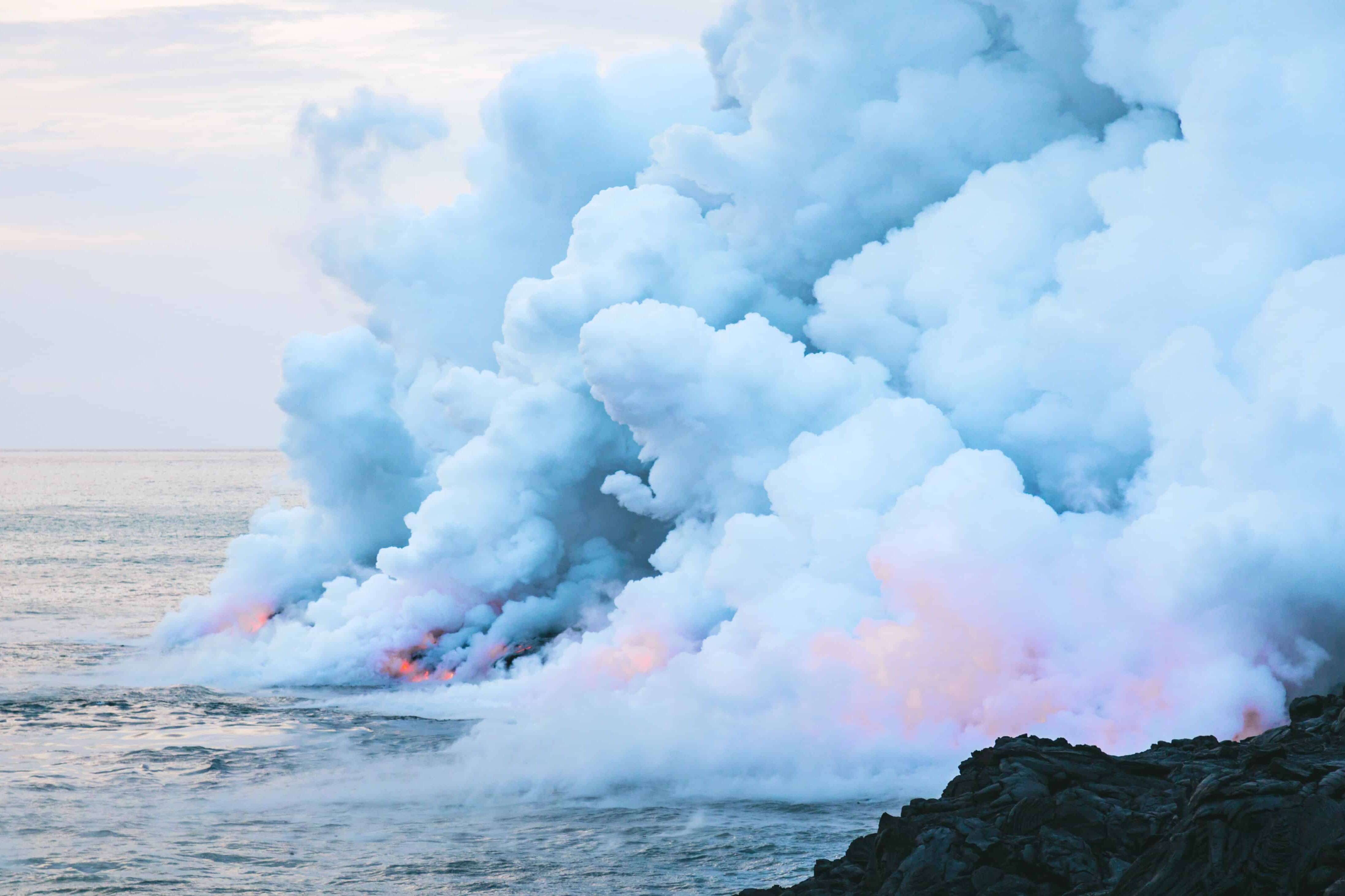 Lava entering ocean and steam rising
