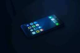 Glowing phone screen against a dark background