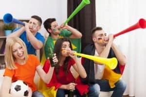 Soccer fans blowing vuvuzela
