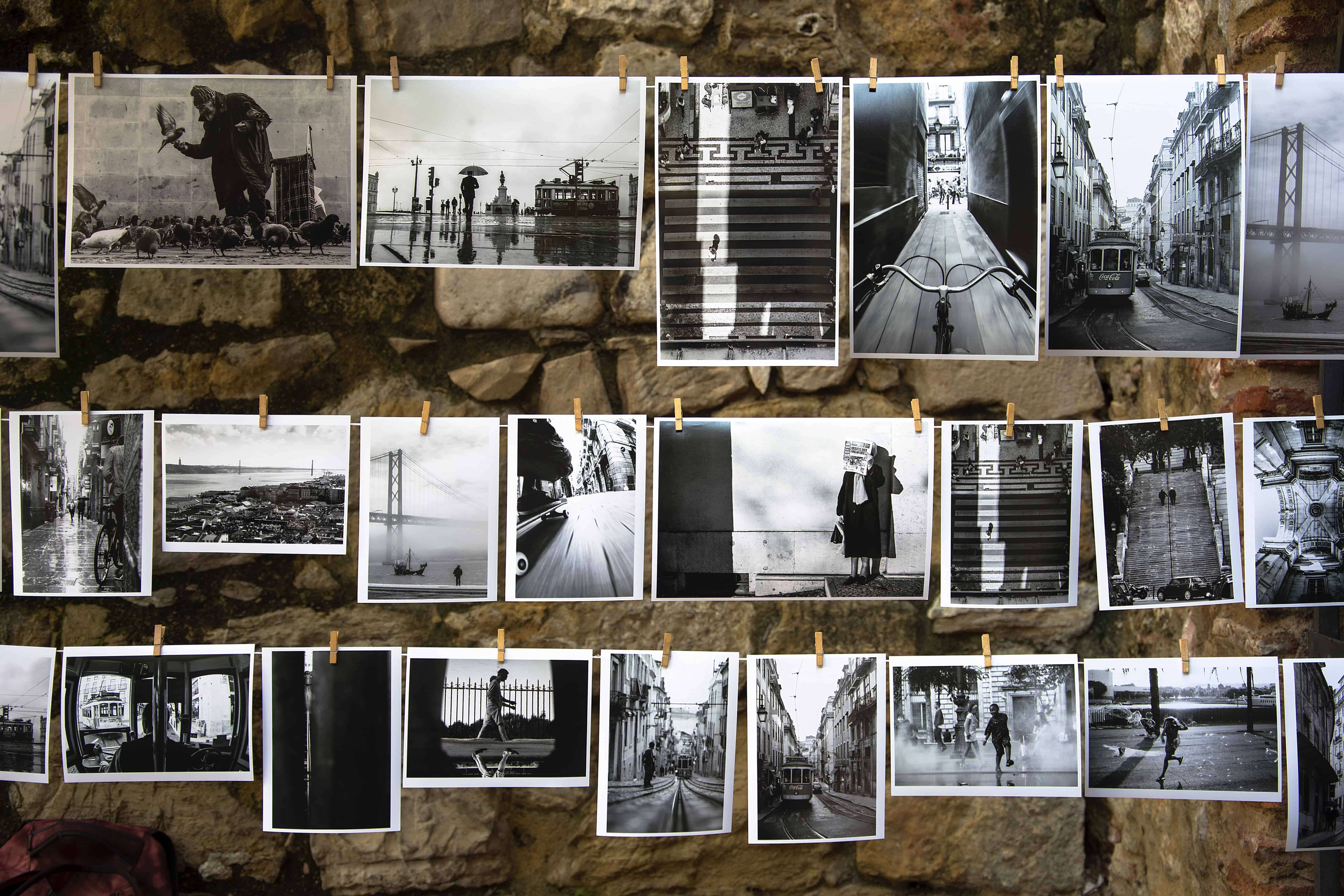 Various black and white photos from a city strung up