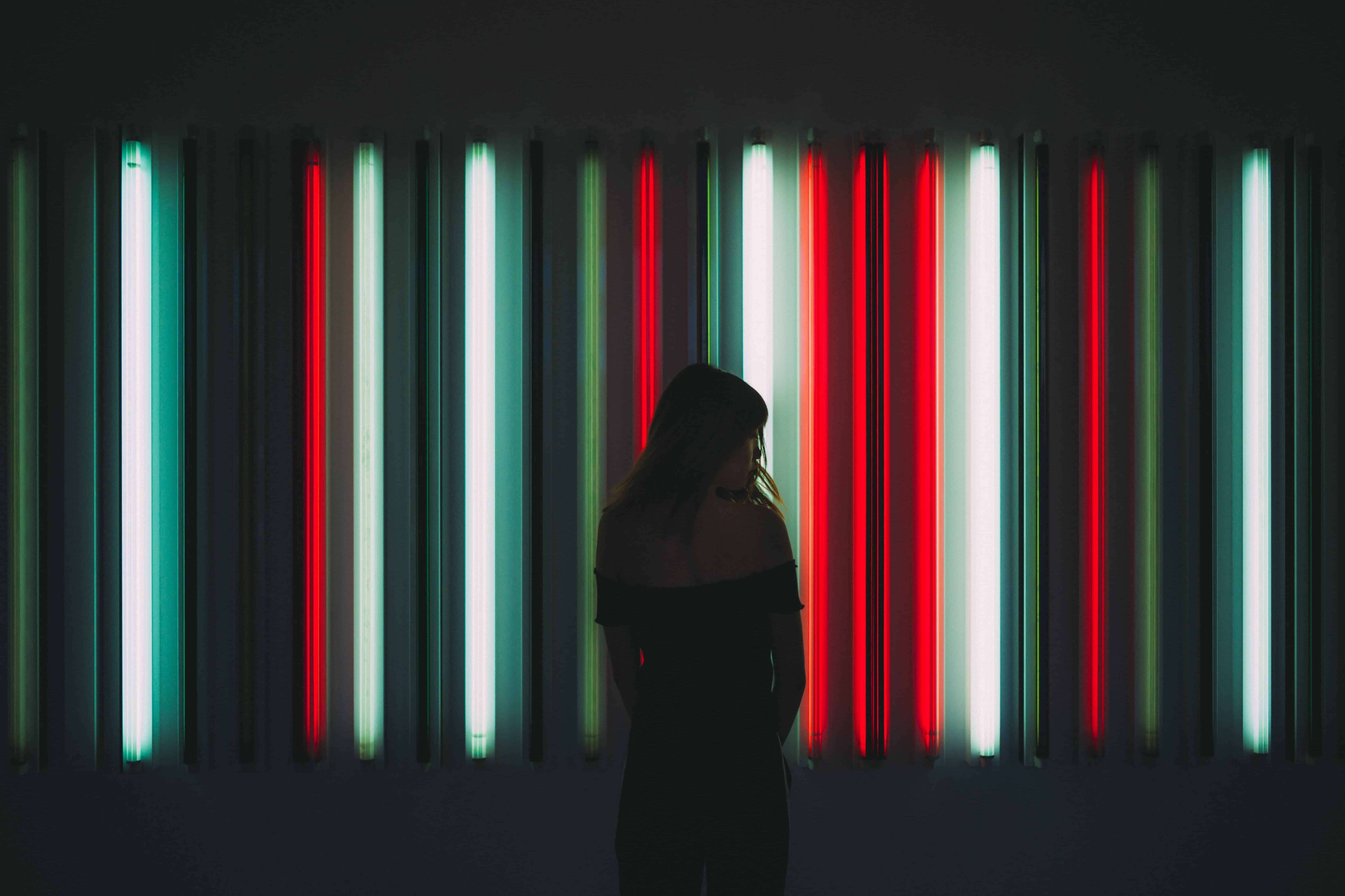 Woman standing against red, blue, and white lights