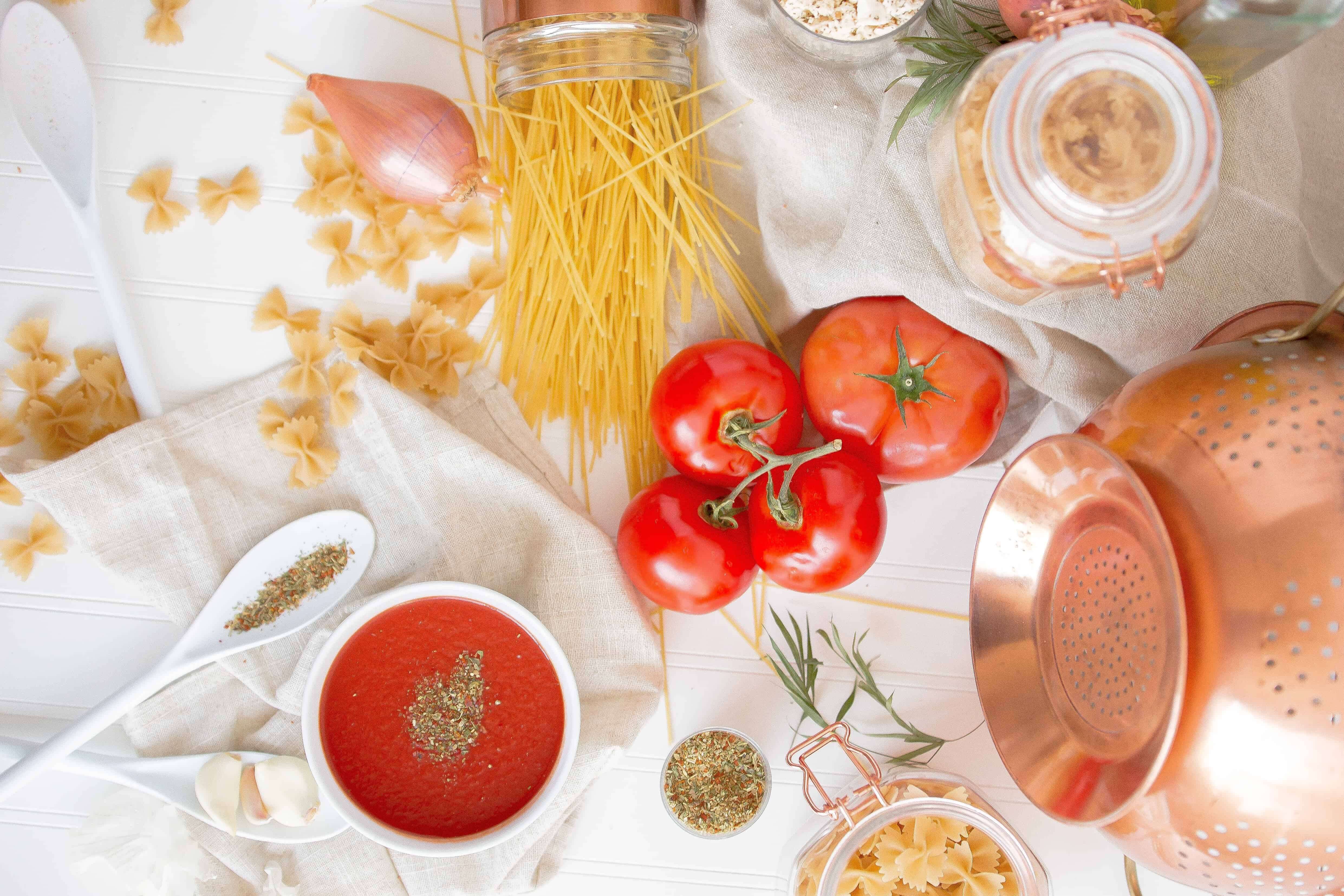 Ingredients and supplies for making pasta scattered on table