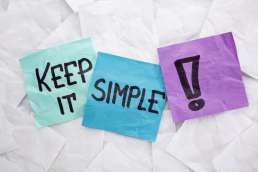 Blue and purple sticky notes that say 'Keep it simple!'
