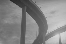 Grayscale photo of diverging highways