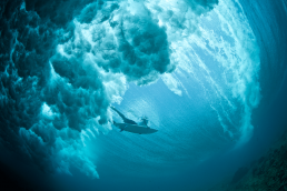 Underwater shot of wave and surfer
