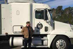 Man standing in front of white semi truck