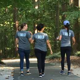 Three women walking with BeBold shirts on