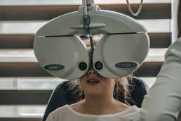 Girl at doctor's office getting her eyes examined