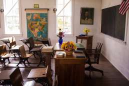 schoolroom with desks and a map