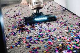 vacuuming up confetti after an event