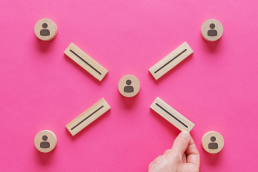 pink background with wooden blocks representing partners